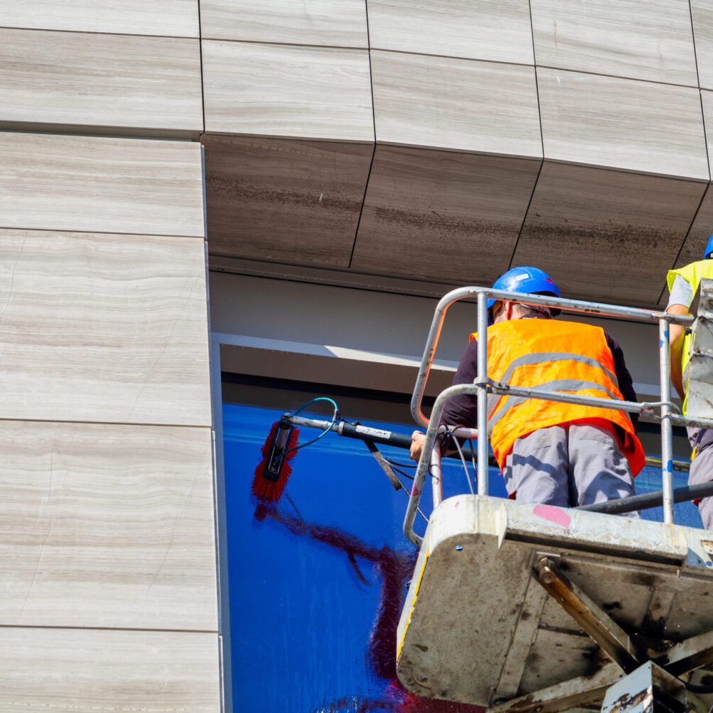 two-window-cleaners-working-in-elevated-work-platf-2026-03-26-07-49-51-utc